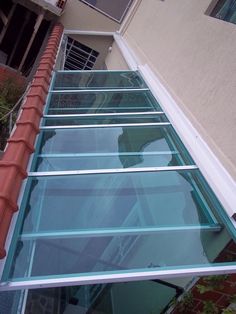 an image of a glass walkway going up the side of a building