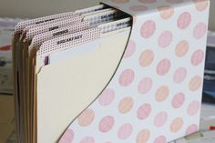 several folders stacked on top of each other in a binder with pink polka dots