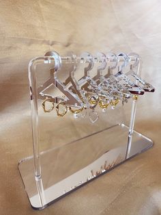 a clear acrylic rack with earrings on it