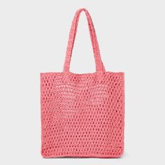 a pink crocheted tote bag on a white background with the handles down