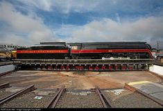 an old train is sitting on the tracks