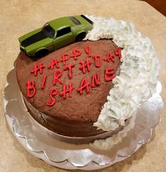 a birthday cake with the words happy birthday shane and a green car on top