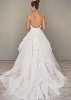 a woman in a white wedding dress looking back