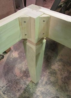 the corner of a wooden table being built