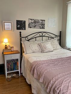 a bed sitting next to a window in a bedroom on top of a hard wood floor