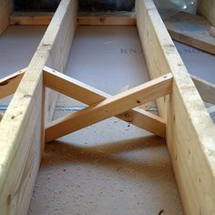 the bottom half of a wooden boat being built