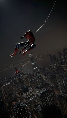 a spider man flying over the city at night
