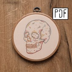 an embroidered skull is shown on a wooden surface