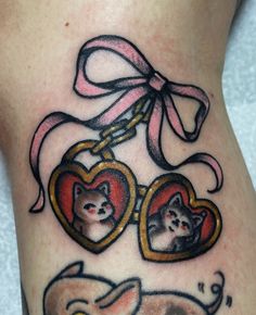 a tattoo with two hearts and cats on it