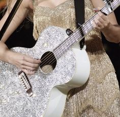 a close up of a person holding a guitar