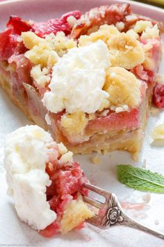 a slice of strawberry crumble pie on a pink plate with a silver serving fork