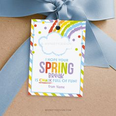 a blue ribbon tied to a brown box with a card saying, hope your spring break is chak full of fun