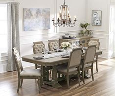 a dining room table with chairs and a chandelier