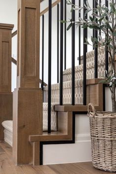 a basket sitting on top of a wooden stair case next to a set of stairs