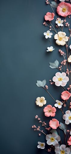 an arrangement of flowers on a dark background