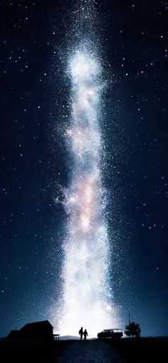 two people are standing under the stars in the night sky, looking up at the milky