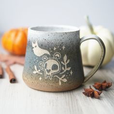 Sip your spooky brews in style with this handmade pottery mug! Not only does it feature a cute ghostly cat skull, but it reminds you to embrace letting go of the old and welcoming new experiences. Pottery To Go Mug, Wheel Thrown Mugs, Mug Shapes, Pottery Handles, Wheel Pottery, Skull Mug, Pottery Patterns, Rustic Pottery, Cat Skull