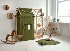 a child's room with a doll house and rocking horse