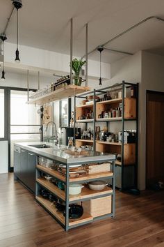 a kitchen with wooden floors and shelves filled with dishes