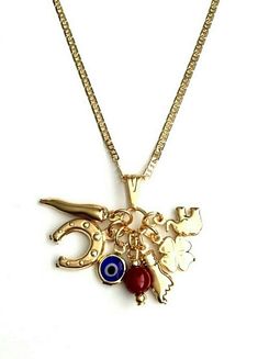 "18k gold filled charm elephant ,evil eye,figa hand,horn clover and horseshoe necklace 20\" long chain. for good luck and money. 18k gold filled cadena de elefante,ojo,trebol,chilli y herradura. 20\" largo cadena . para buena suerte,prosperidad,dinero." Vintage Charm Necklace, Lucky Charm Necklace, Horseshoe Necklace, Accesories Jewelry, Wrist Jewelry, For Good Luck