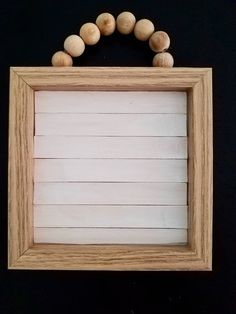 a wooden frame with some wood beads around it