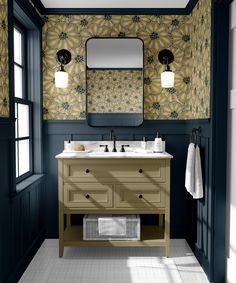 a bathroom with two sinks and a large mirror above the sink is decorated in blue and gold