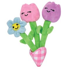 three stuffed flowers in a pink vase with a smiley face on the top and bottom