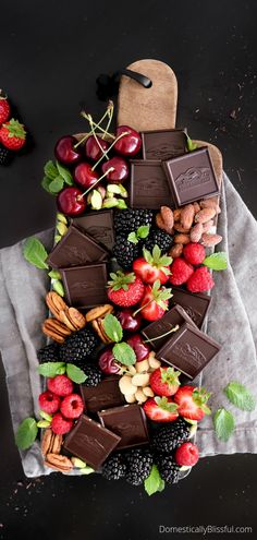 chocolate dessert board with strawberries, raspberries, almonds and other fruit