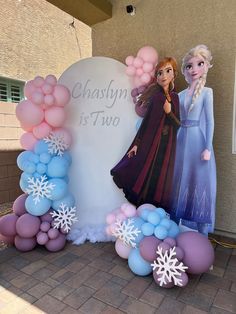 a frozen princess themed balloon arch with balloons