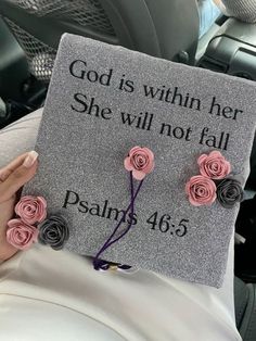 someone is holding up a graduation cap with roses on it that says, god is within her she will not fall