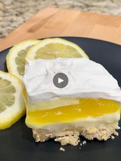 a piece of lemon pie on a black plate