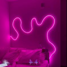 a bed in a room with neon lights on the wall