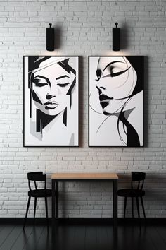 two black and white paintings hang on the wall above a table in front of a brick wall