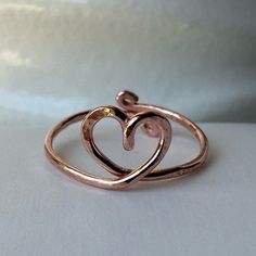 two intertwined hearts ring sitting on top of each other