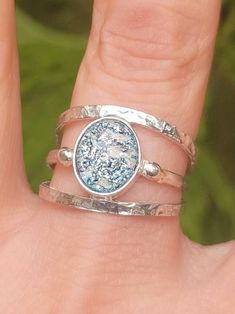 a woman's hand with two different rings on it