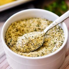 garlic bread seasoning in a white bowl with a spoon