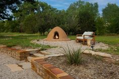 an outdoor fire pit in the middle of a field