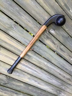 an old hammer is laying on top of a wooden deck