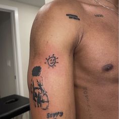 a man's arm with tattoos on it and an image of the sun behind him