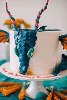 a birthday cake decorated with grapes and candles