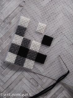 a close up of a cross stitch pattern on a piece of cloth