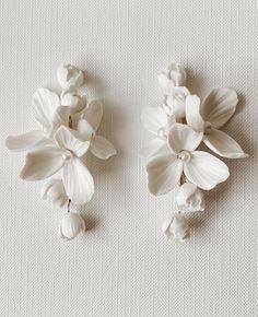 two white flowers are placed next to each other