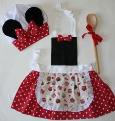 a minnie mouse dress and hat with a wooden spoon