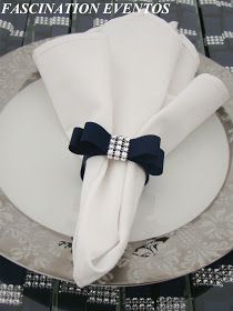 a white plate topped with a napkin and a blue bow tie on top of it