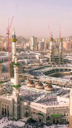 an aerial view of the grand mosque in the middle of the city with many people around it