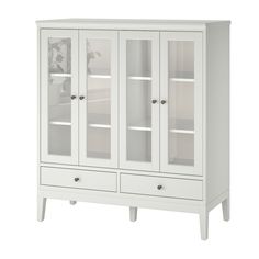 a white cabinet with glass doors and drawers