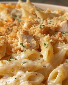 pasta with chicken and parmesan cheese in a white bowl