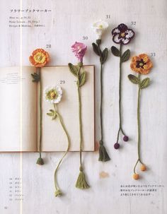 an open book with flowers attached to it