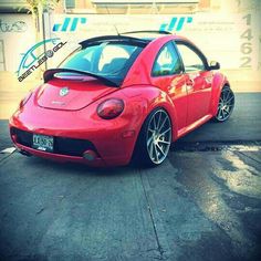 a red car parked in front of a building