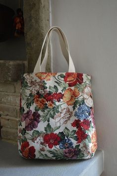 a flowered bag sitting on top of a window sill